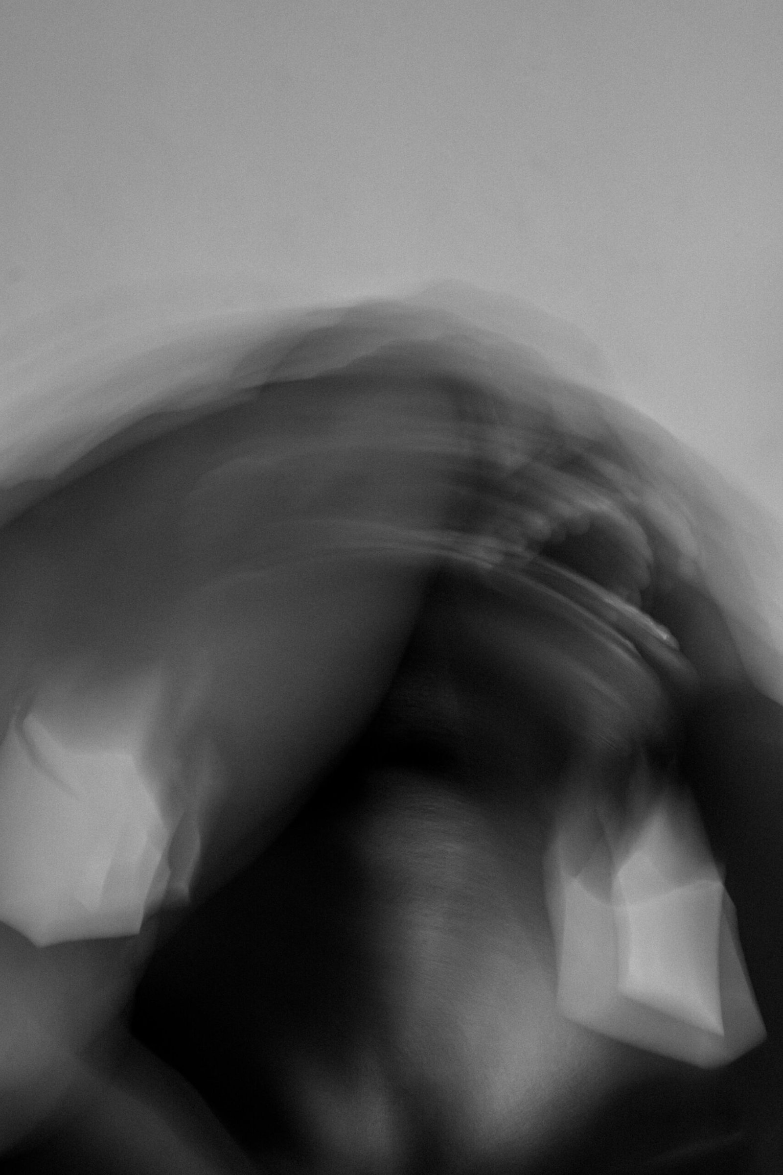 Abstract black and white portrait capturing intense emotion and movement.